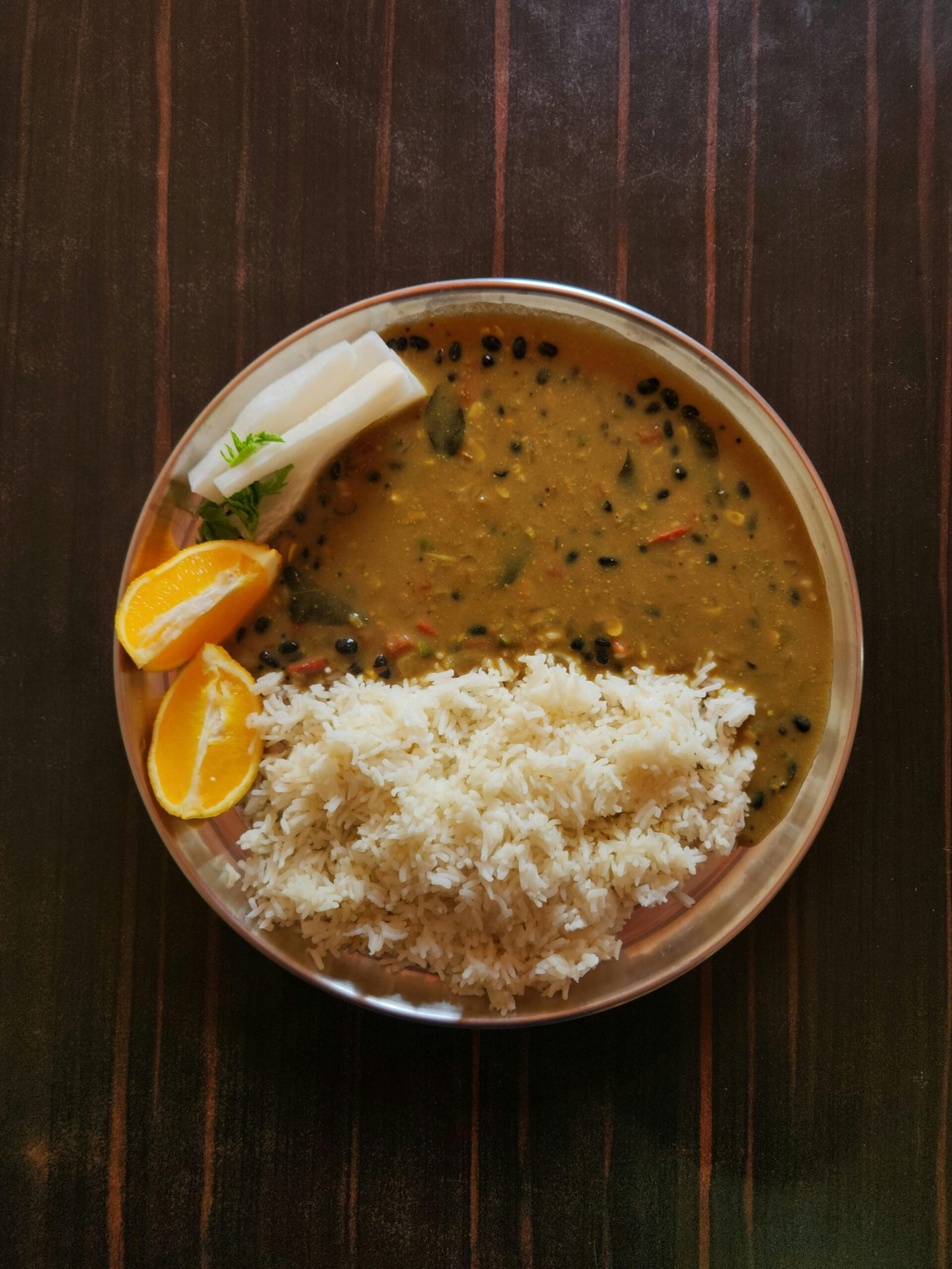 Indian dal with mustard seed tempering and basmati rice in a steel plate showing Tier 1 weight loss food