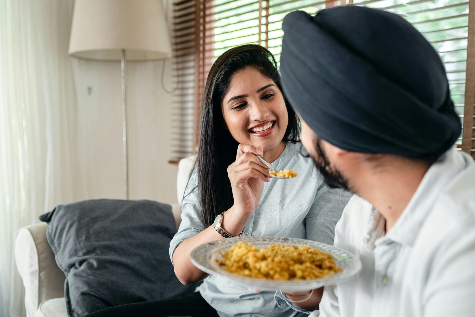 Indian couple eating a vegetarian home cooked meal together showing that Indian food supports weight loss