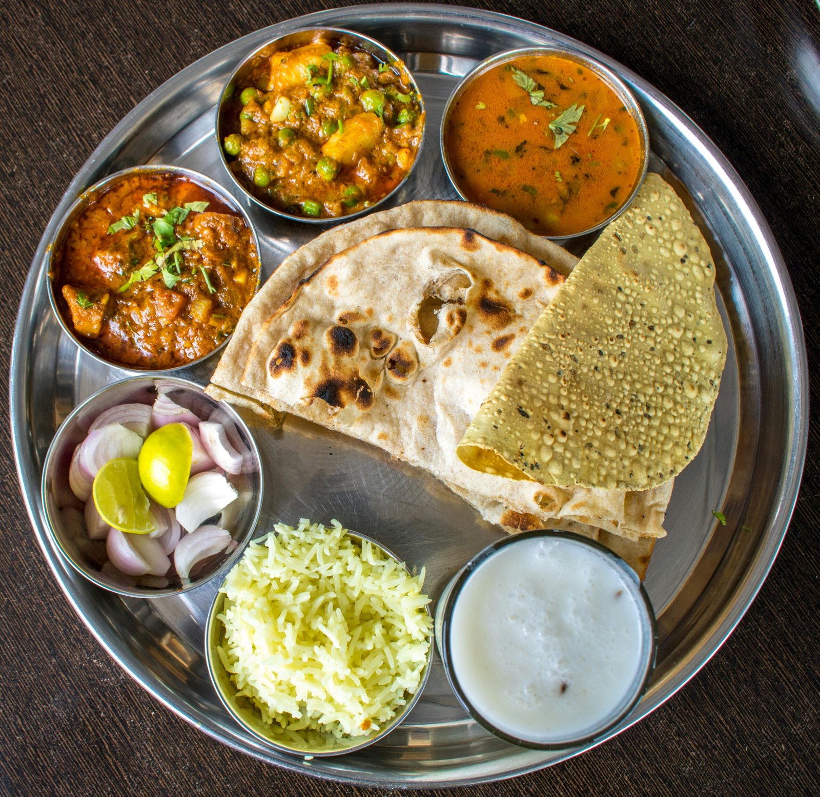 Balanced Indian vegetarian thali with dal, sabzi, roti, rice and curd for weight loss